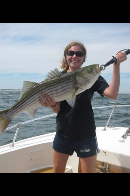 Our First Mate Christine shows off her large striper caught on the Merrimack RIver, MA